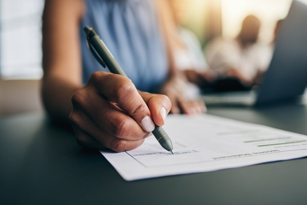 Closeup, hand and a person with a document for accounting, finance paperwork or business. Desk, off